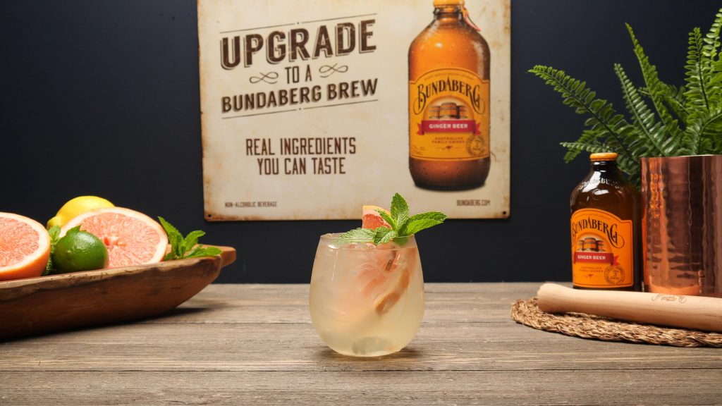 Gin Gin Mule garnished with a sprig of mint and a grapefruit wheel