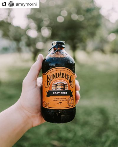 Hand holding a full bottle of Bundaberg Root Beer